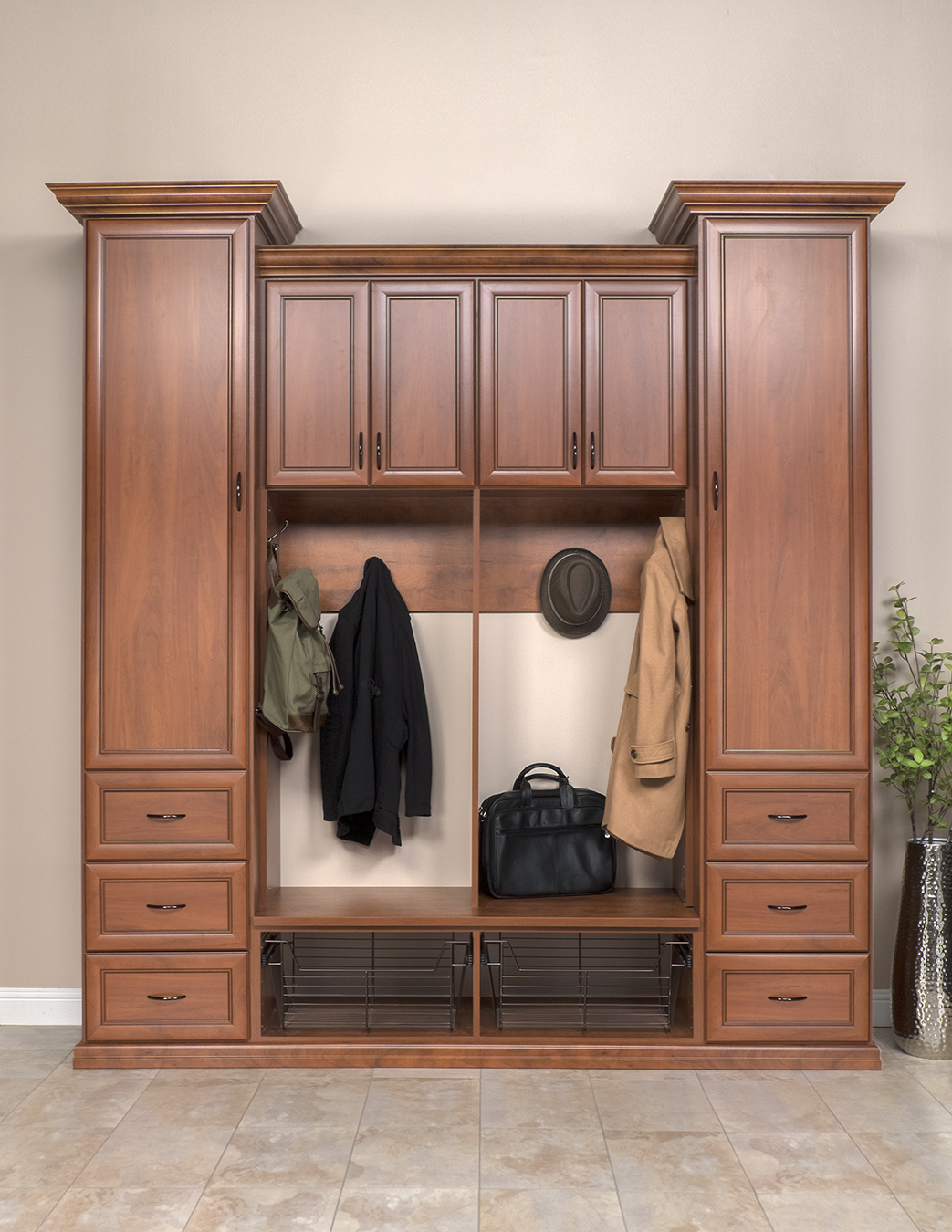 Traditional wood cabinets with coat hooks and drawers for easy organization